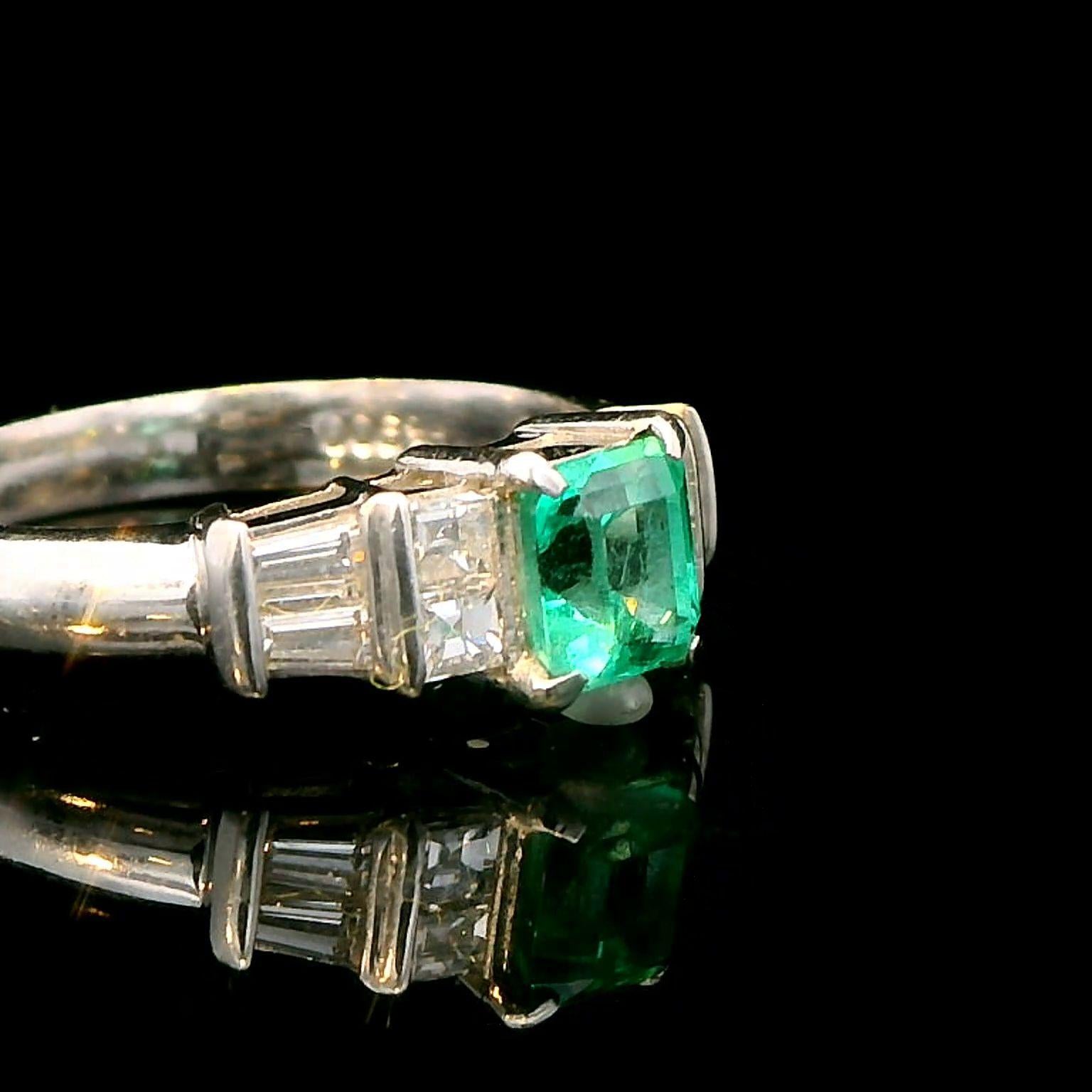 Platinum Ring with 0.55ct Emerald and 0.38ct Diamond